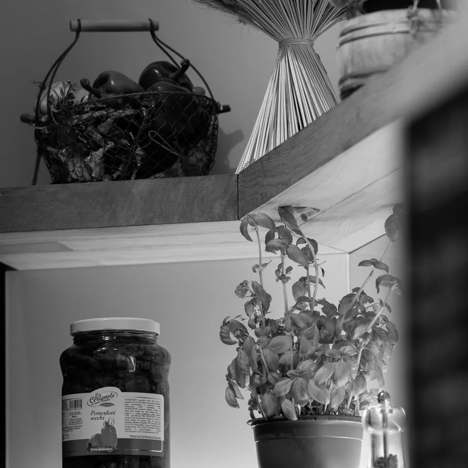 Shelf with herbs, baskets and preserving jars